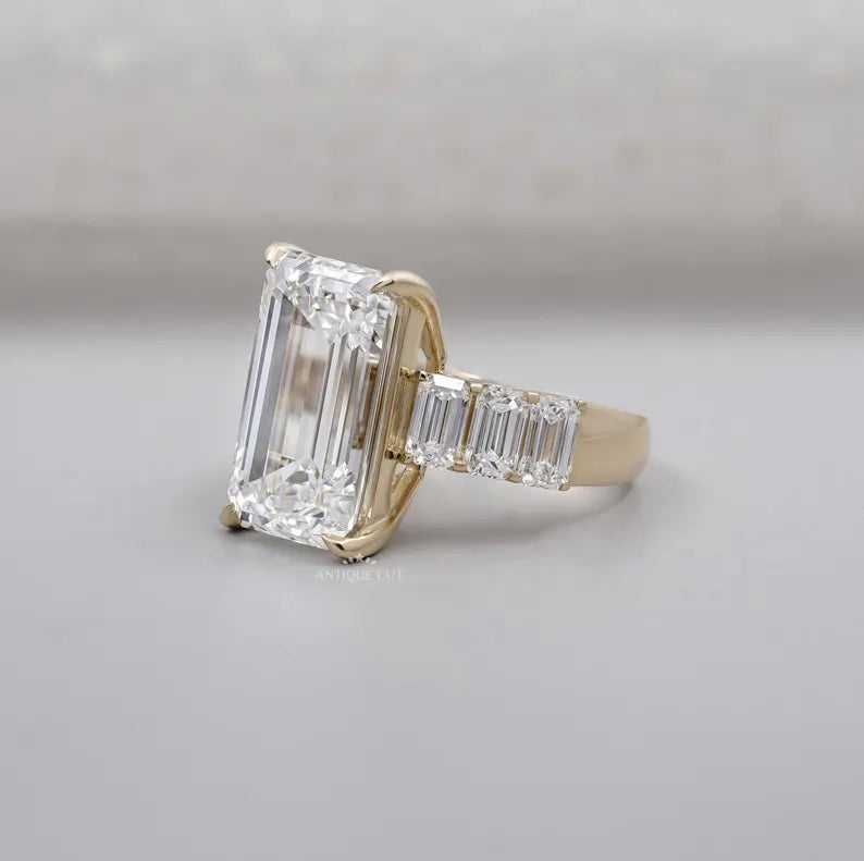 Yellow gold engagement ring with emerald cut center stone