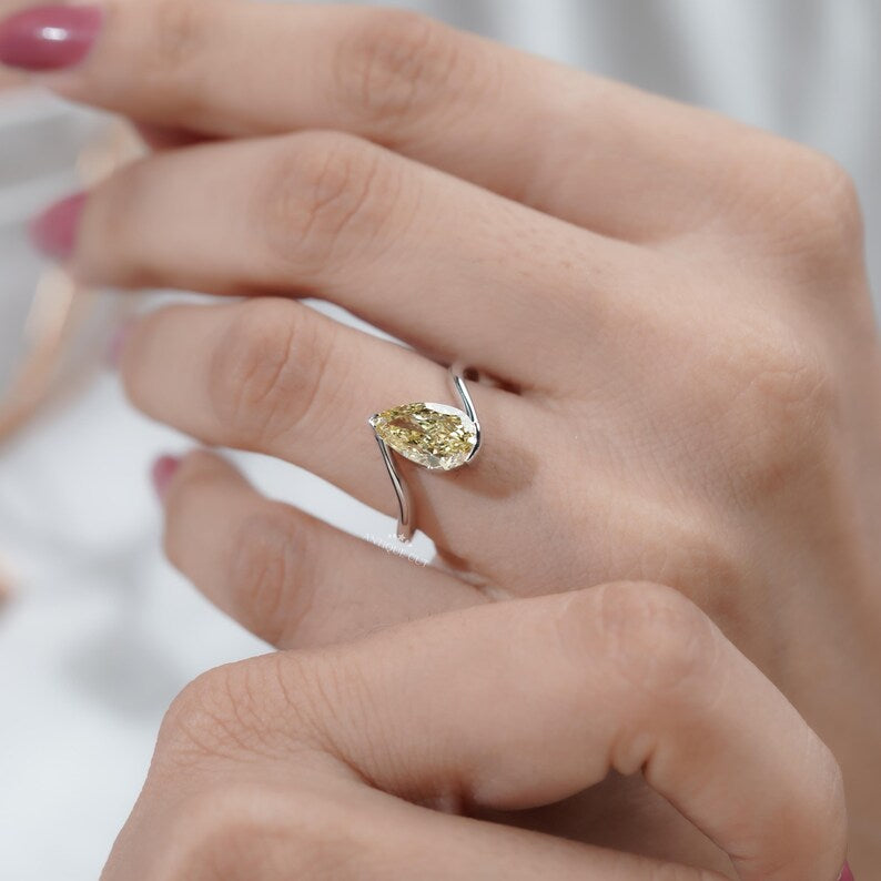 Bridal pear shaped yellow diamond bypass ring