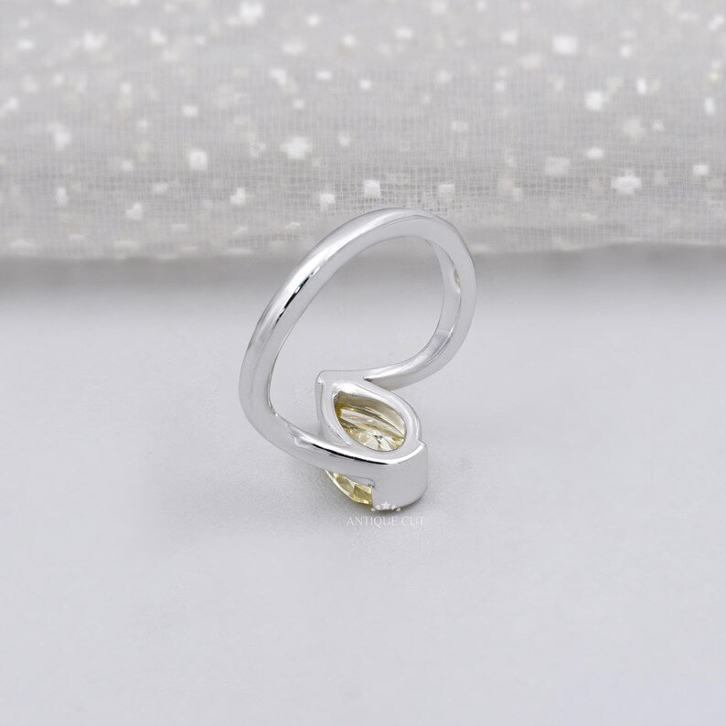 Pear shaped yellow diamond ring on hand