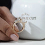 Detailed view of step-cut emerald center with tapered accents