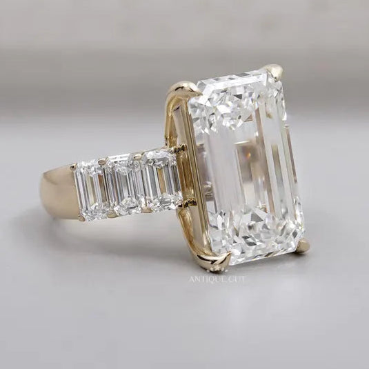 Step-cut emerald diamond with tapered side diamonds