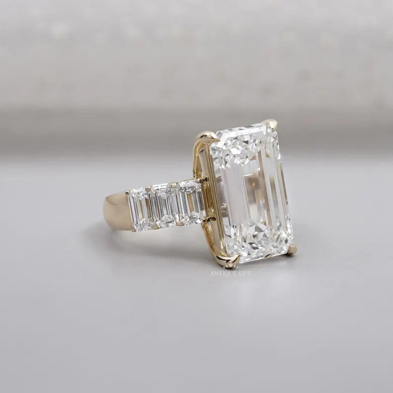 Step-cut emerald diamond with tapered side diamonds