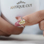 Detailed shot of pear shaped yellow diamond and prong setting