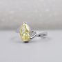 Close-up of pear shaped yellow diamond in white gold setting