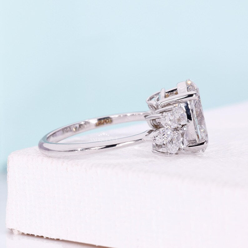 White gold oval diamond engagement ring featuring floral marquise side stones