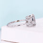 White gold oval diamond engagement ring featuring floral marquise side stones