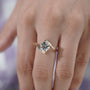 Round cut solitaire-inspired ring with curved gold shoulders