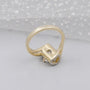Side view of yellow gold engagement ring with hidden halo