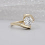 Round cut diamond engagement ring with curved bypass band