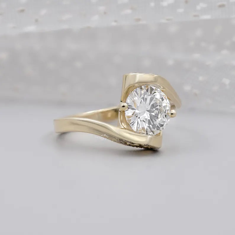 Round cut diamond engagement ring with curved bypass band