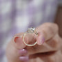Close-up of round center diamond in sculptural gold setting