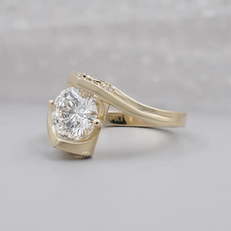 Yellow gold round diamond ring shown on a woman’s hand