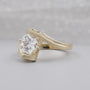 Yellow gold round diamond ring shown on a woman’s hand