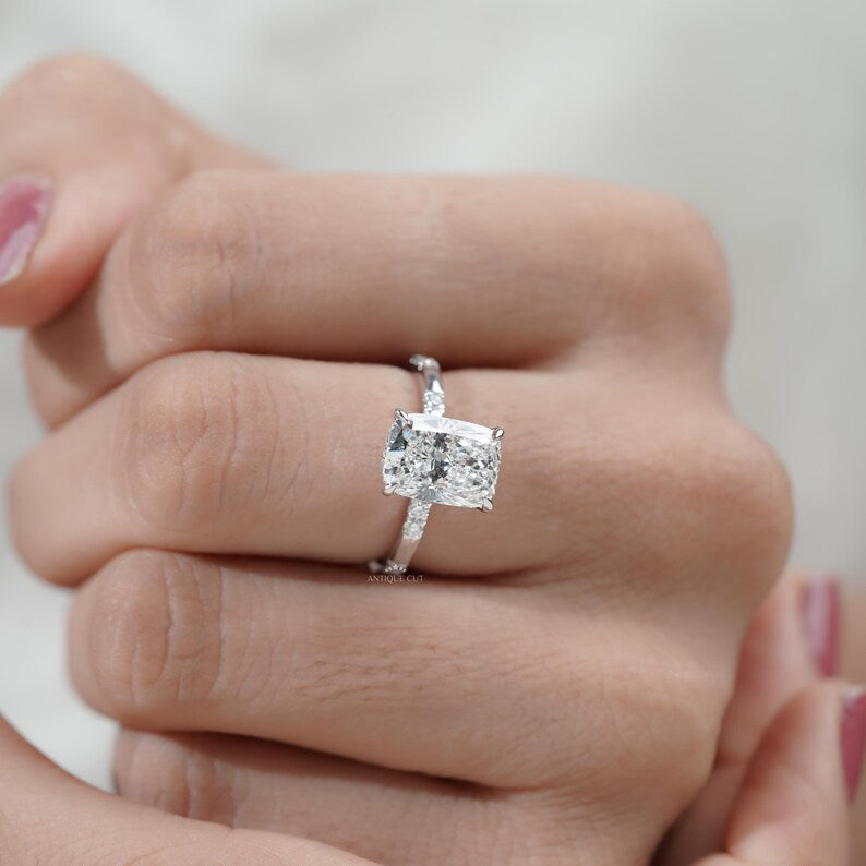 Minimalist cushion cut engagement ring with hidden halo and sparkling lab grown diamond.