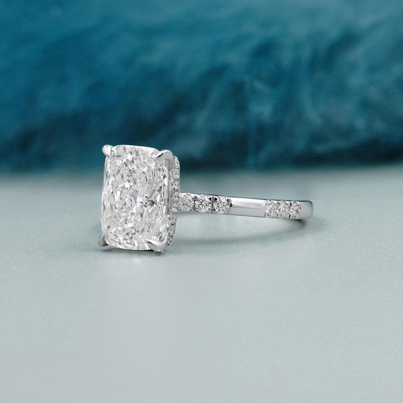 IGI certified cushion cut lab grown diamond ring with hidden halo and four-prong setting.