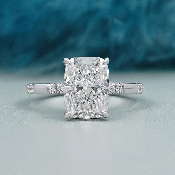 Cushion cut lab grown diamond engagement ring with hidden halo in white gold solitaire setting.