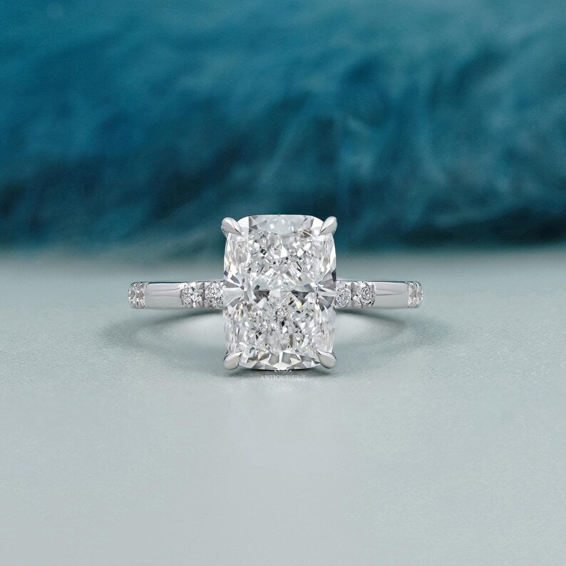 Cushion cut lab grown diamond engagement ring with hidden halo in white gold solitaire setting.