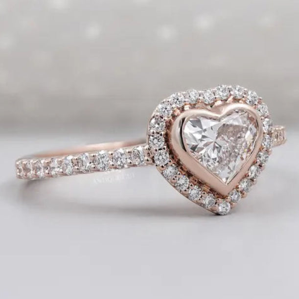 Heart shaped diamond engagement ring with bezel halo