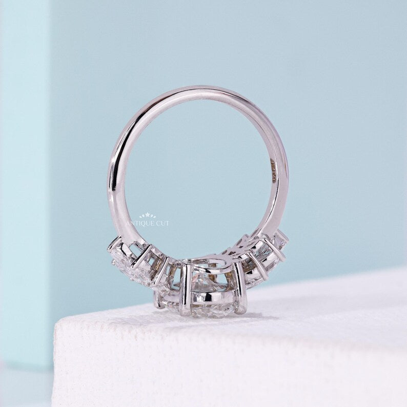 Oval cut diamond ring with elegant marquise side stone details