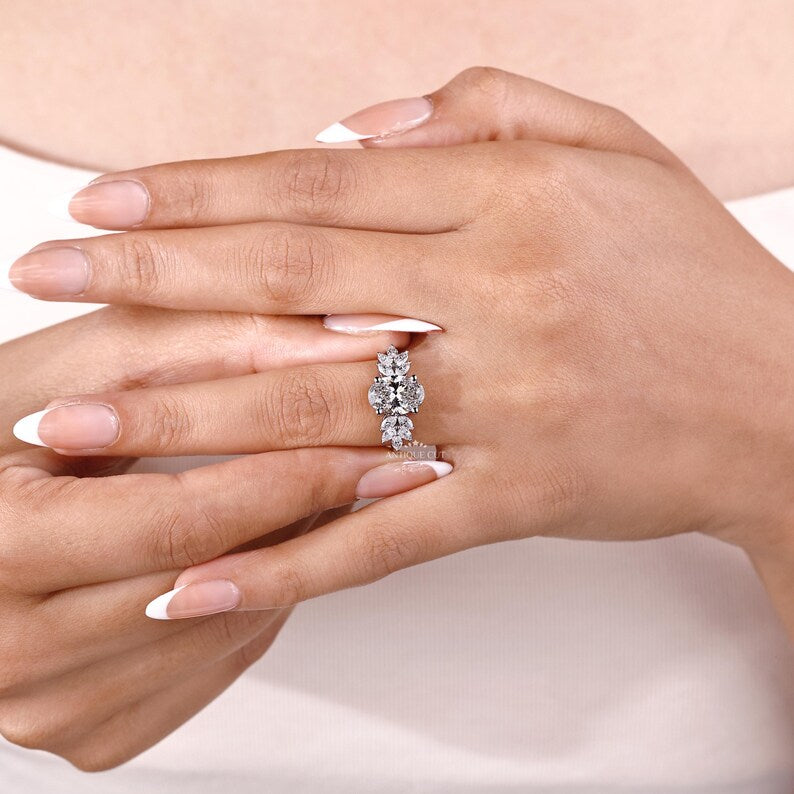 Lab grown oval diamond ring with marquise cut side stone design