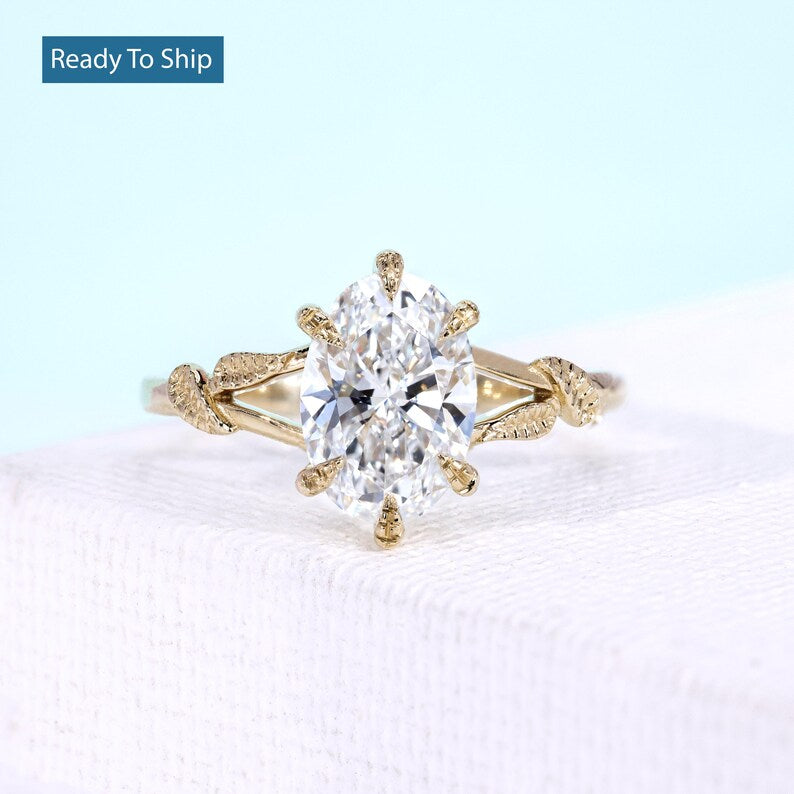 Nature inspired vine engagement ring with oval diamond in yellow gold