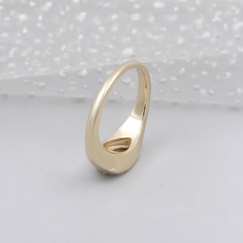 East west bezel set engagement ring in yellow gold