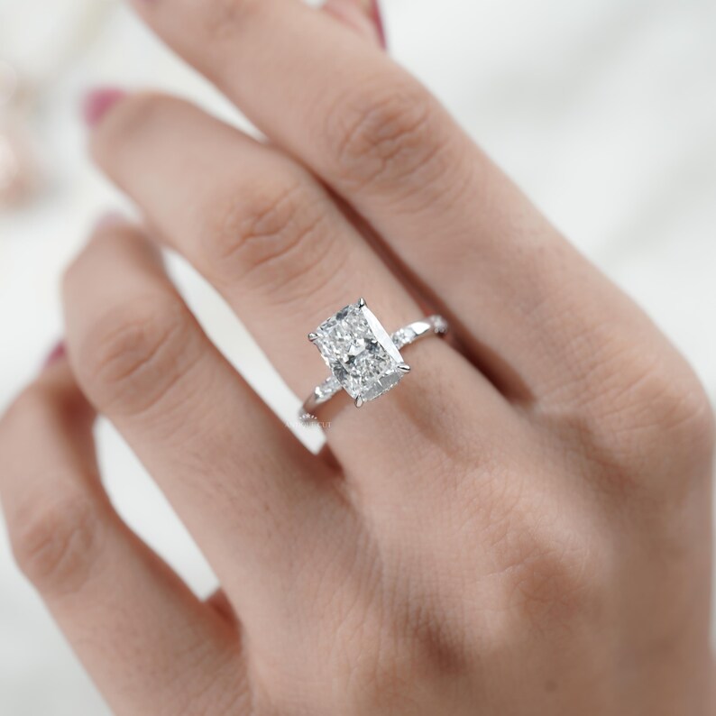White gold hidden halo cushion cut diamond ring handcrafted for modern brides.