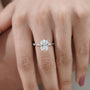 Cushion cut solitaire diamond ring with hidden halo and delicate accent diamonds on the band.