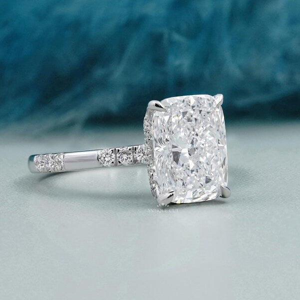 Elegant cushion cut diamond engagement ring featuring a hidden halo and polished white gold band.