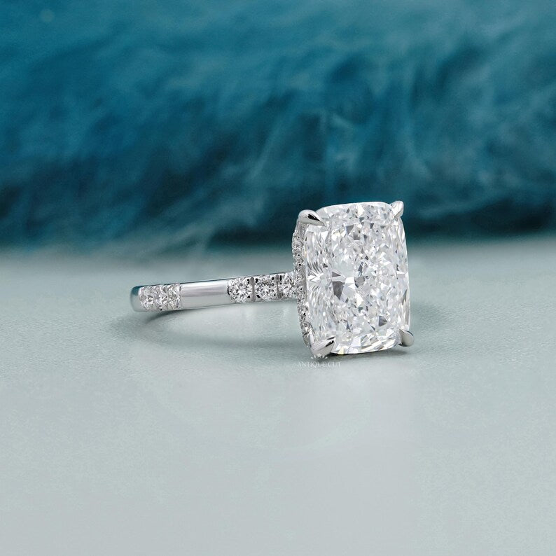 Elegant cushion cut diamond engagement ring featuring a hidden halo and polished white gold band.