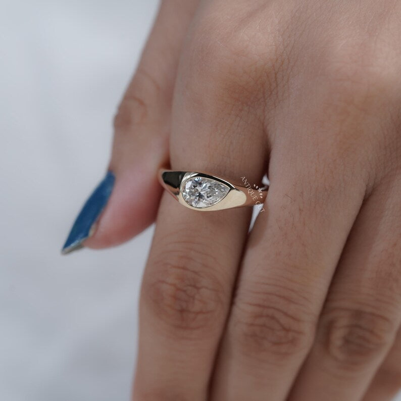 Polished yellow gold signet jewelry with pear diamond