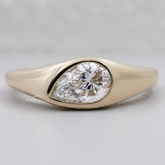 Pear cut lab grown diamond signet ring in yellow gold