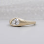 Low profile pear diamond ring shown from the front