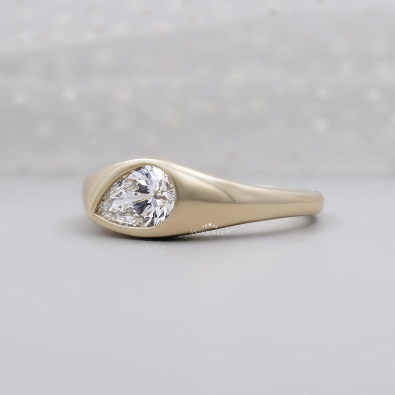 Low profile pear diamond ring shown from the front