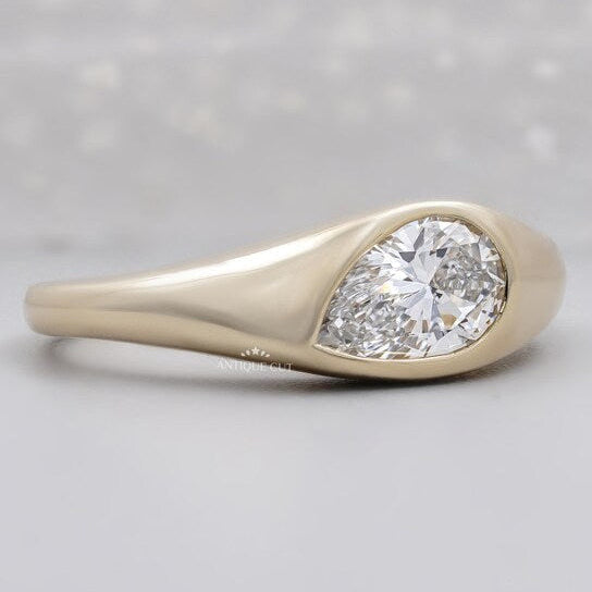 East west pear diamond ring with smooth bezel setting