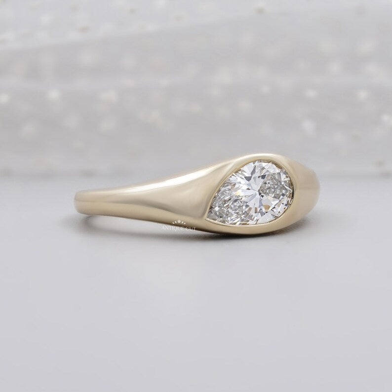 East west pear diamond ring with smooth bezel setting