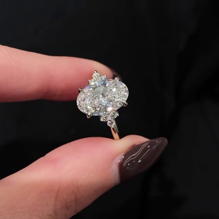 oval diamond ring with round side stones white gold setting