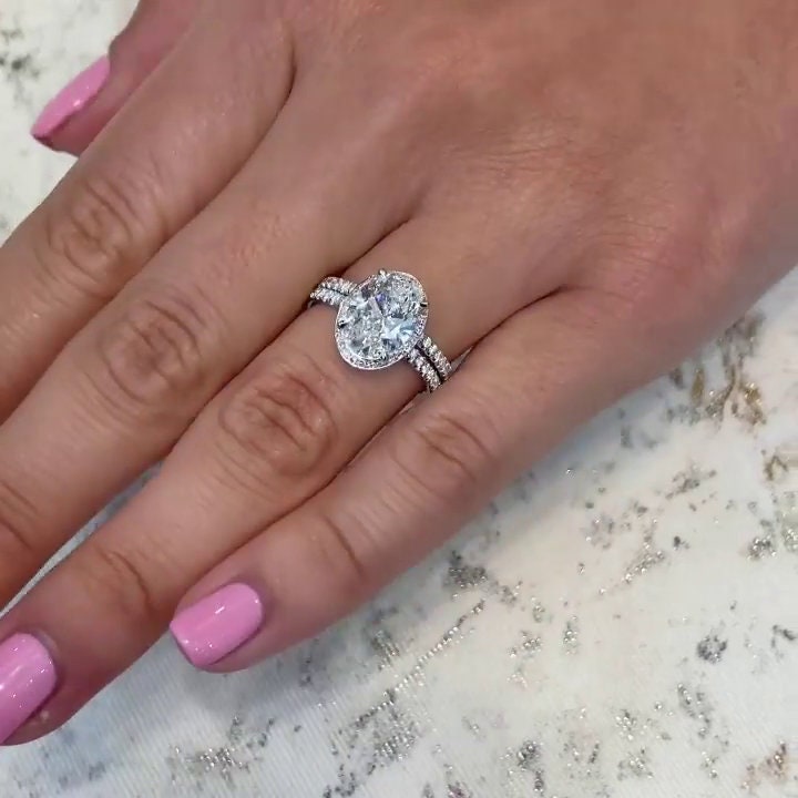 Oval diamond engagement ring with pavé diamond accents