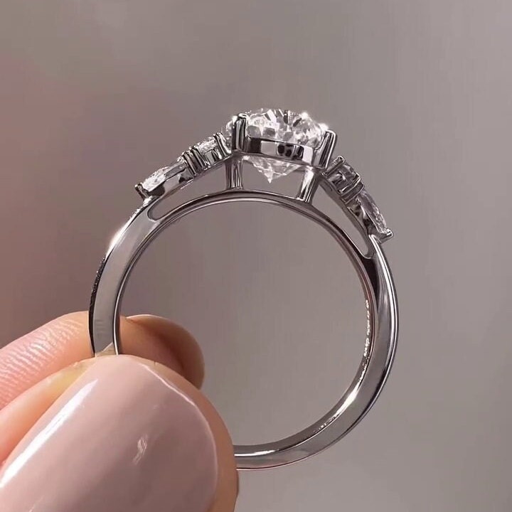 oval center diamond with pear and round diamond accents close up