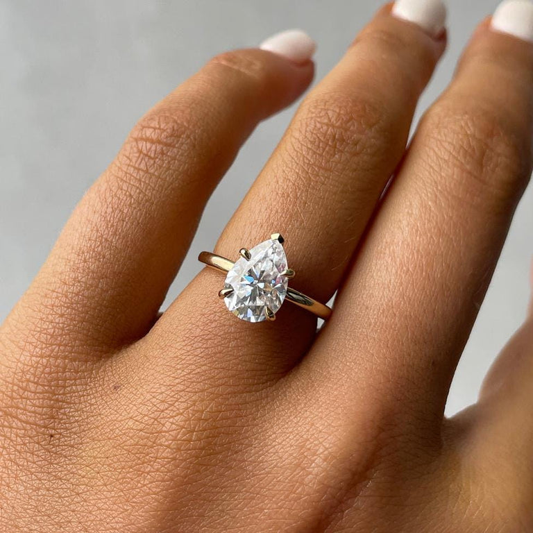 Pear cut solitaire engagement ring in yellow gold