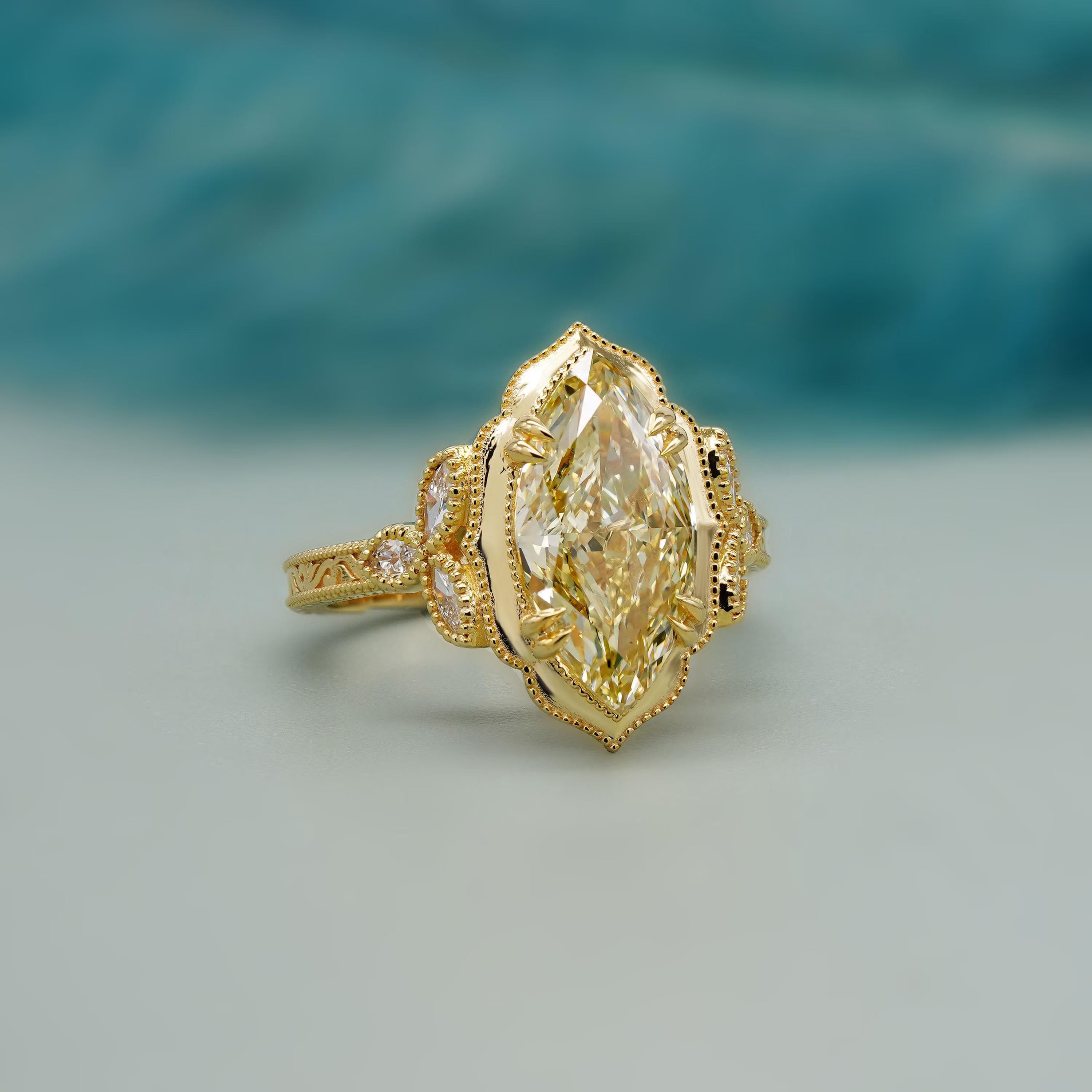 Marquise cut yellow diamond cathedral engagement ring in yellow gold