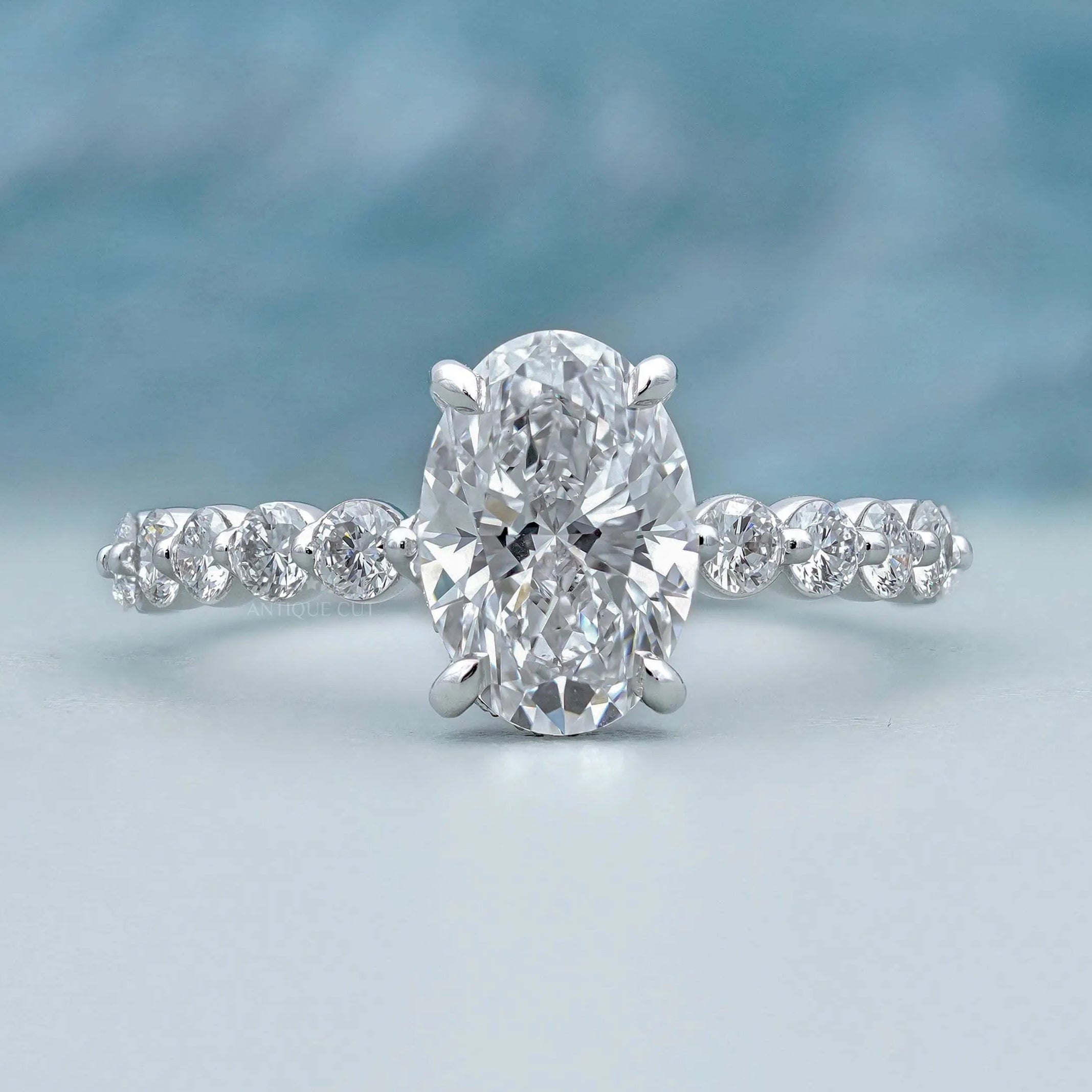 Oval hidden halo engagement ring in white gold