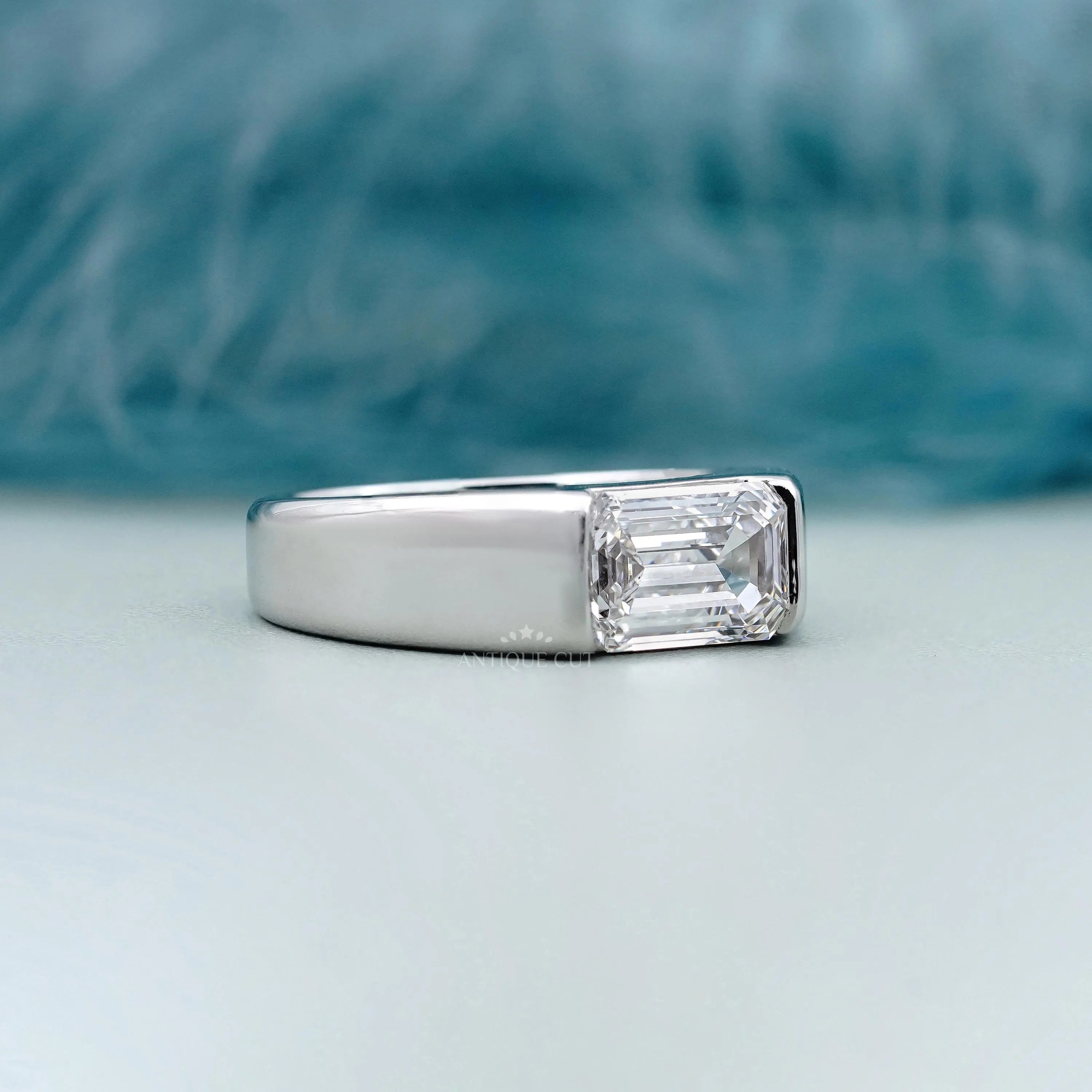 East West emerald cut diamond men's engagement ring in white gold