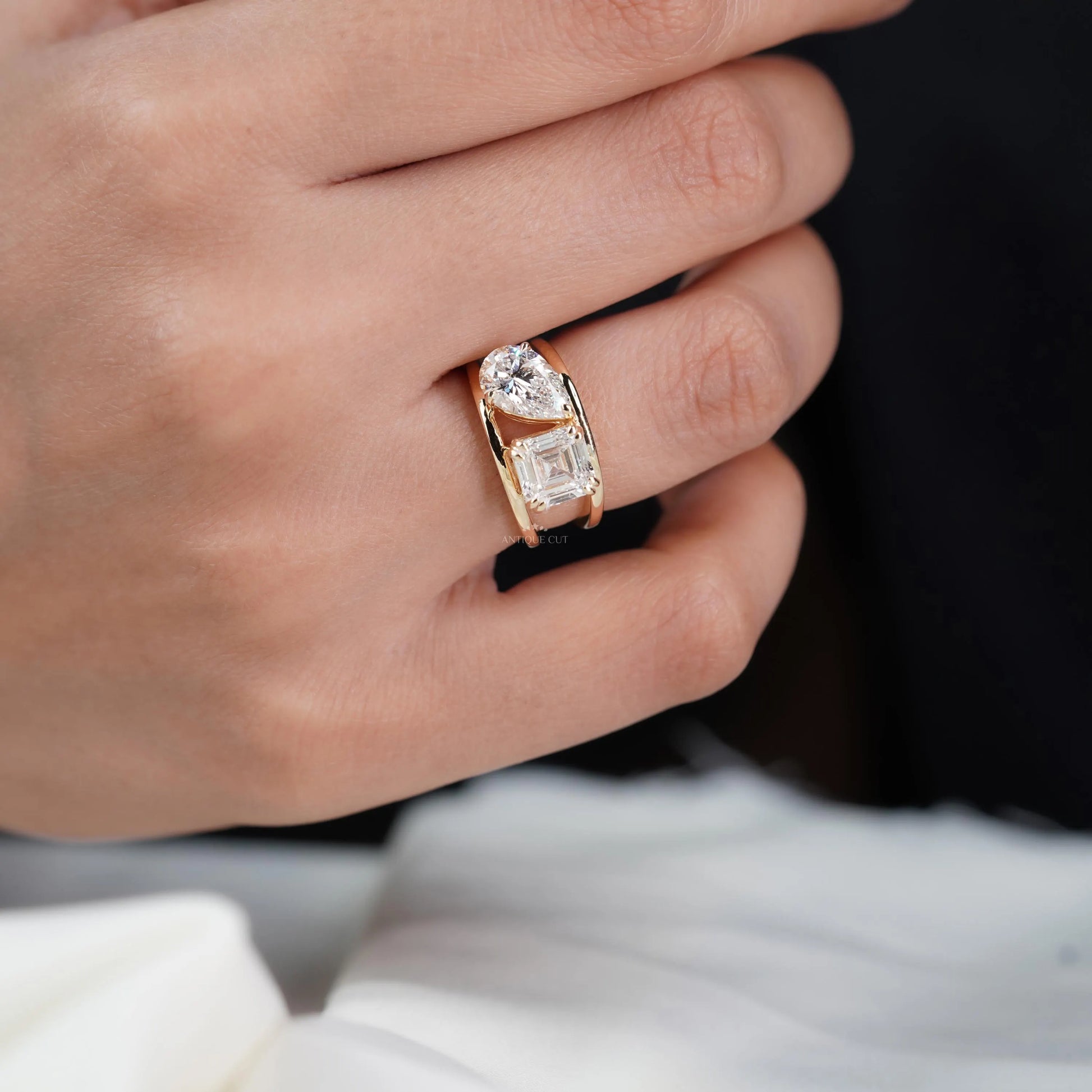 Two stone diamond ring with emerald and pear cuts