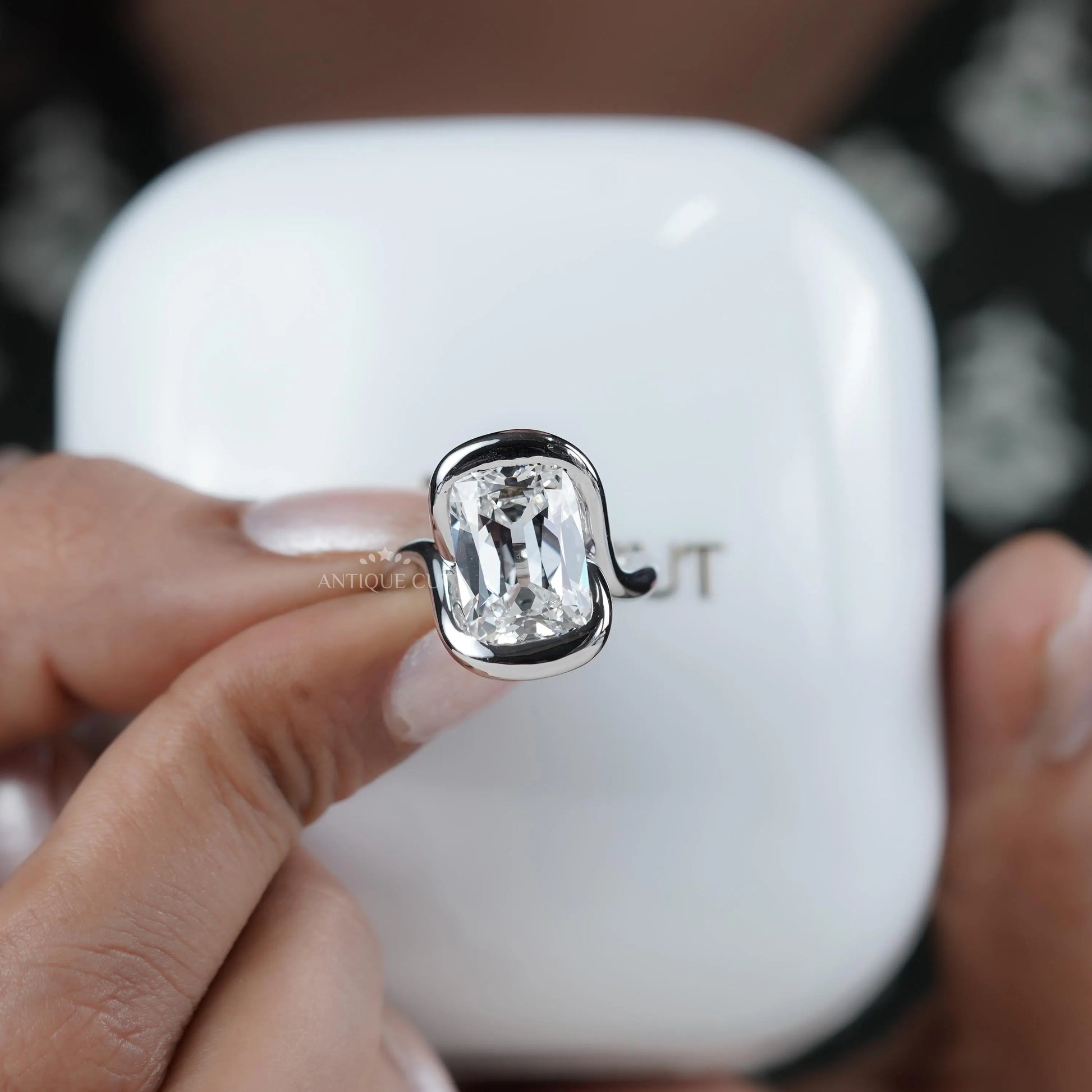 Swirl bezel set diamond engagement ring with unique details
