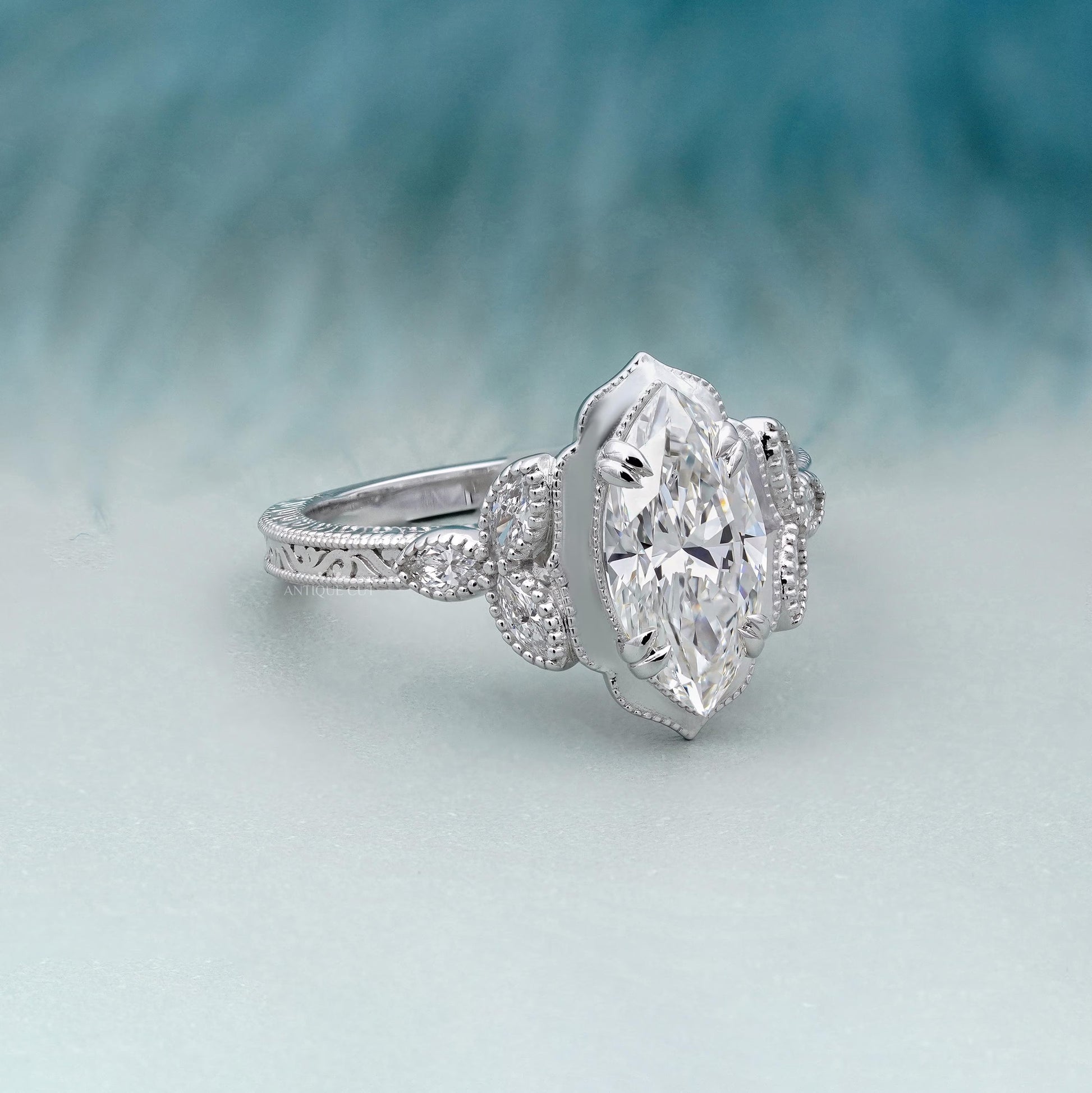 Marquise cut vintage engagement ring with diamond side stones