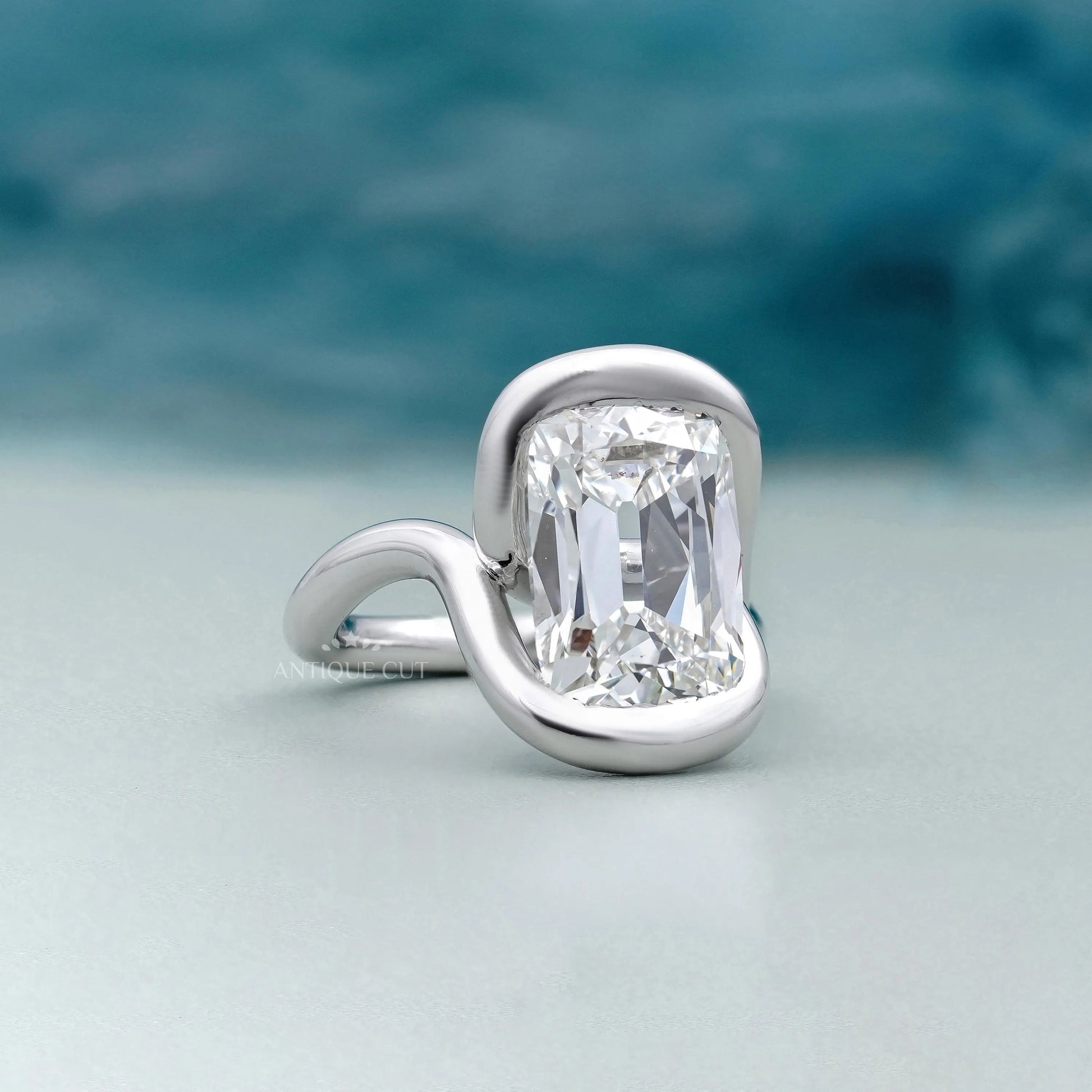 Old mine cushion cut diamond engagement ring with swirl bezel setting