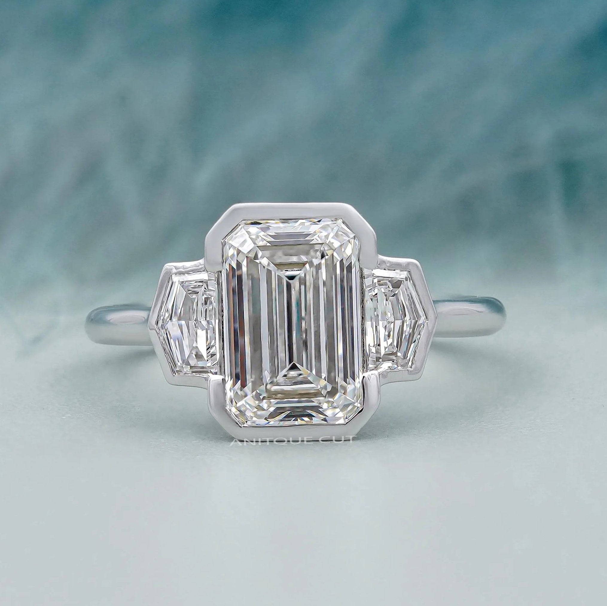 Three stone emerald cut diamond ring in white gold