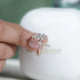 Diamond ring held by a hand with 'AntiqueCut' branding in the background