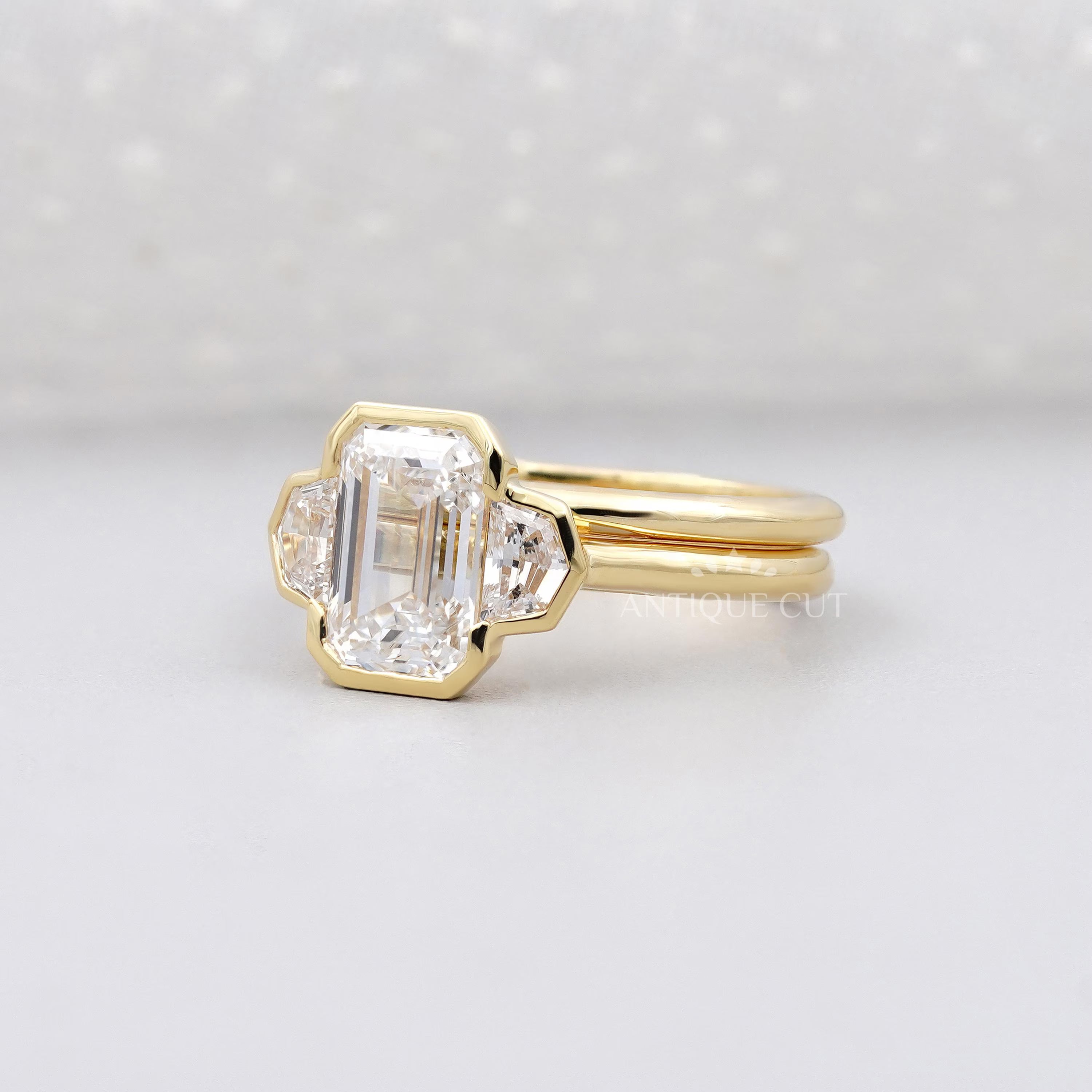Gold ring with a diamond on a light gray background

